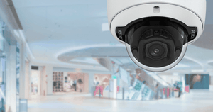 Pelco Sarix Professional 4 Series Dome Camera set against background of mall for security.