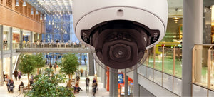 Sarix Professional 4 Series Dome Camera with view of shopping mall full of shoppers in background.