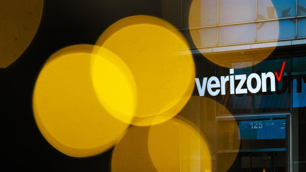 Verizon logo on building with number address and glowing yellow orbs in front.